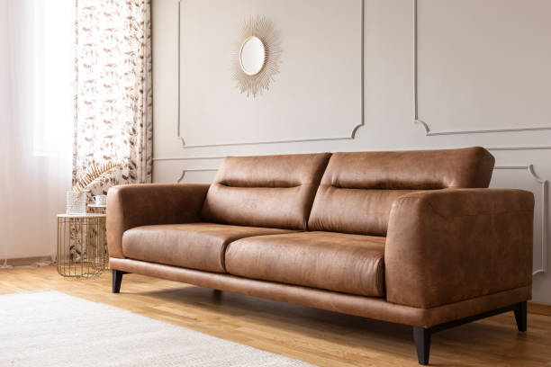 Real photo of a leather couch in a living room interior